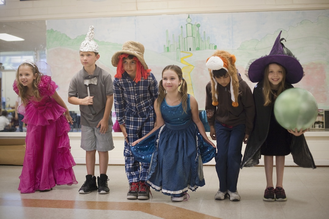 Group of 6 kids dressed up as characters from The Wizard of Oz.